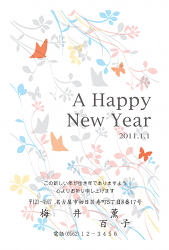 A HAPPY NEW YEAR 野の草花をバックにしたカラフルな年賀状